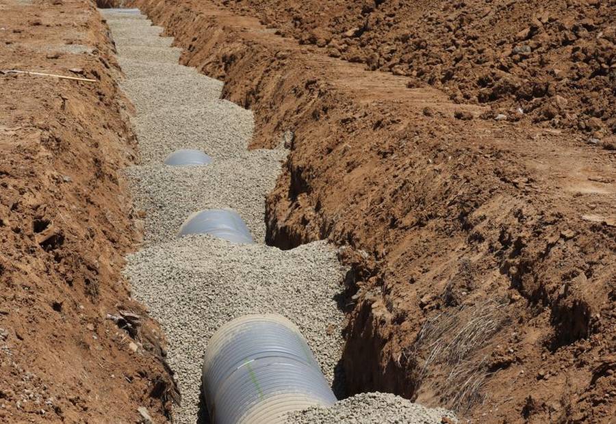 Soil profile exposed in a backhoe pit showing clay horizons